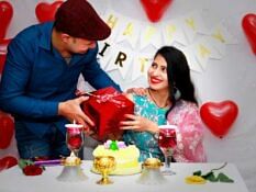 A Nepali couple cutting a birthday cake.